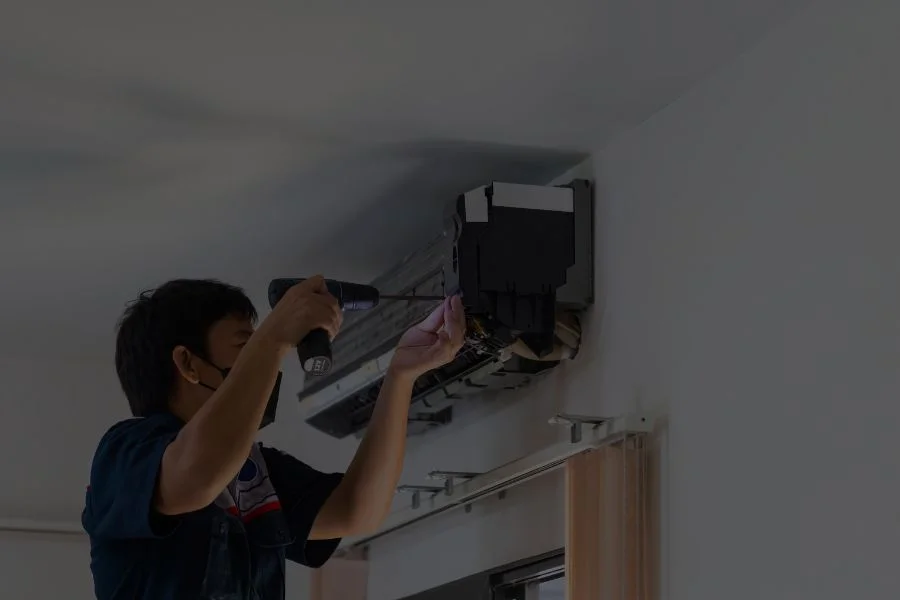 repairman fixing air conditioning system